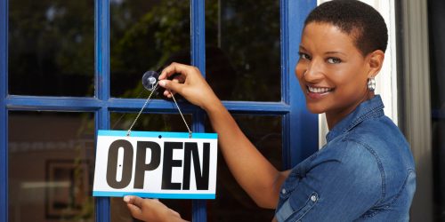 Woman standing in front of retail store.